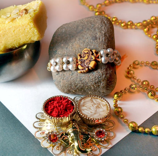 Ganesha Rakhi with double strand beaded Rakhi with Batisa Slice and thali