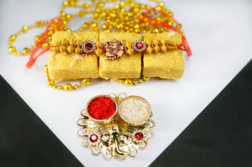 Orange Beads & Pearl rakhi with Batisa slice and Golden thali.