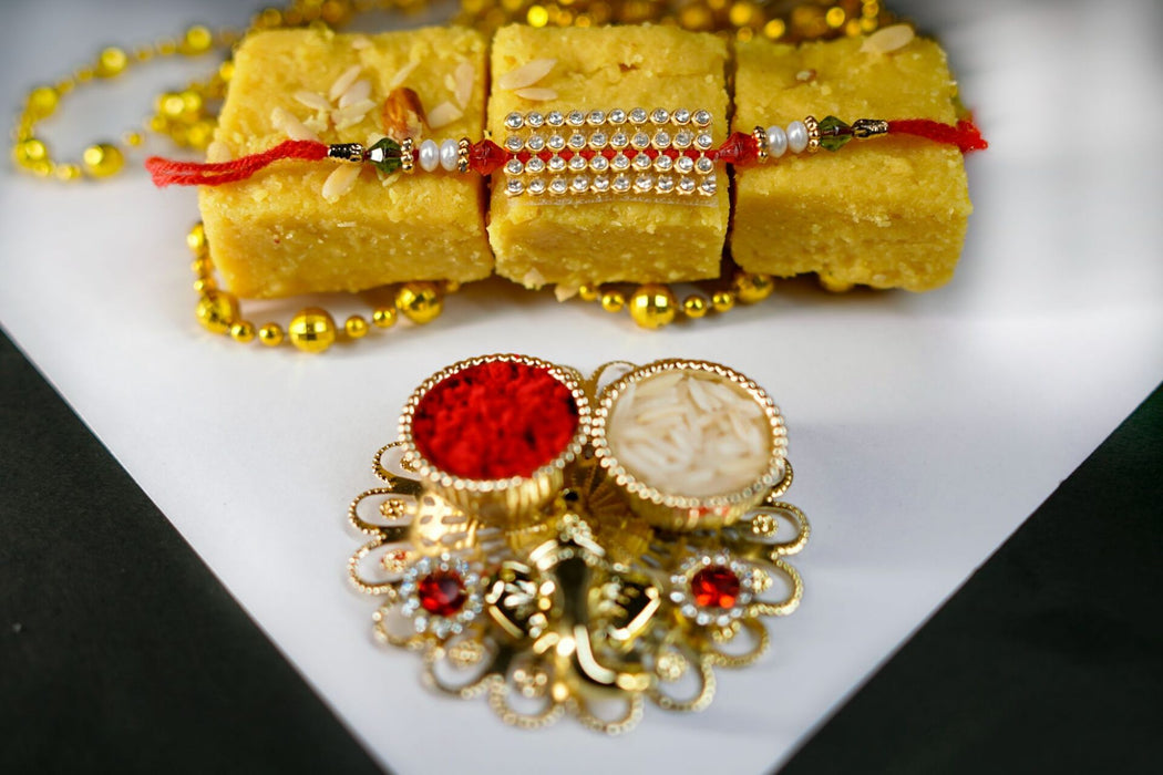 Stunning Pearl-crystal rakhi with Batisa and Thali.