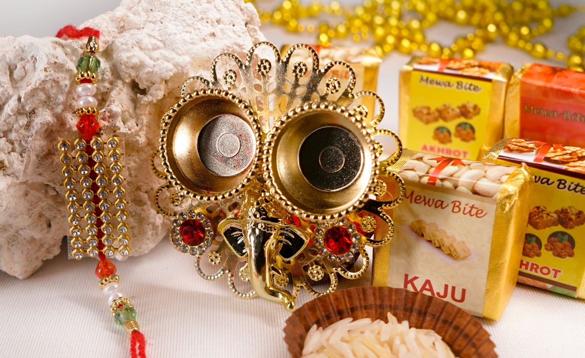 Stunning Pearl-crystal rakhi with Mewa bites and Thali.