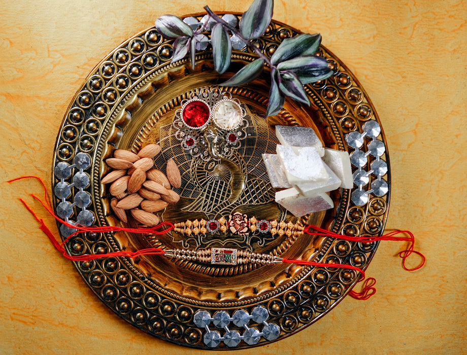 Stone Rakhi Veera + Beads Rakhi Ganesha Om + Thali with 200gm Kaju Barfi + 200 gm Almonds