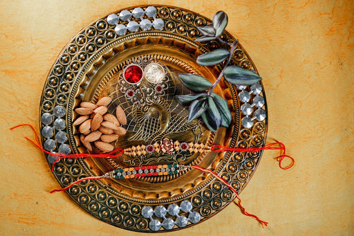 Beads Rakhi Ganesha Om and Beads Rakhi with 200gm Almonds and Thali